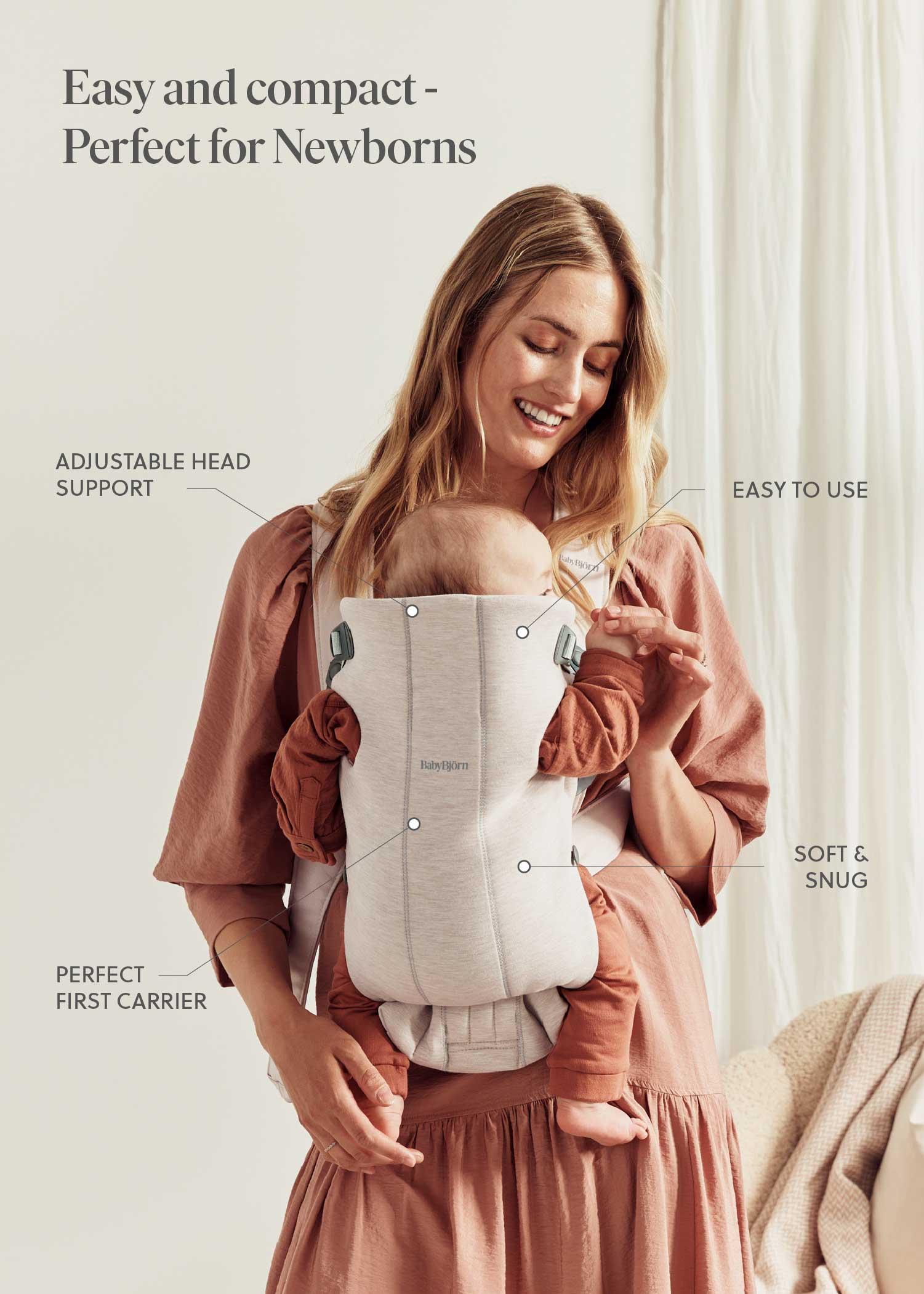 A woman smiles while holding a baby in a soft, adjustable carrier. Text highlights the carrier's features: easy to use, compact, perfect for newborns.